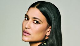 Close-up portrait of Julia Jones with sleek, side-parted black hair, softly smoky eye makeup and muted pink lipstick.